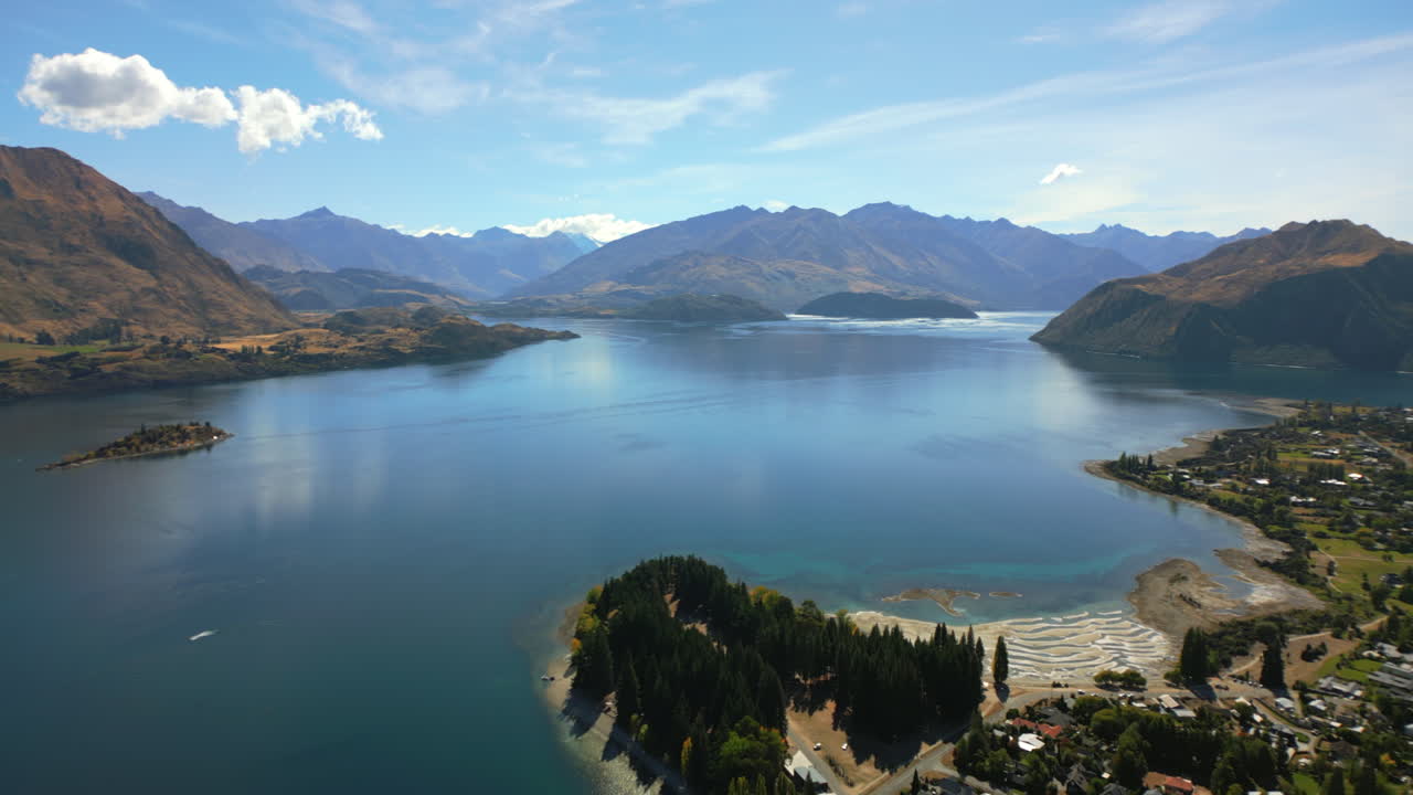 Lake Wānaka is the seat of the town of Wānaka in the Otago region of South Island, New Zealand - aerial push forward