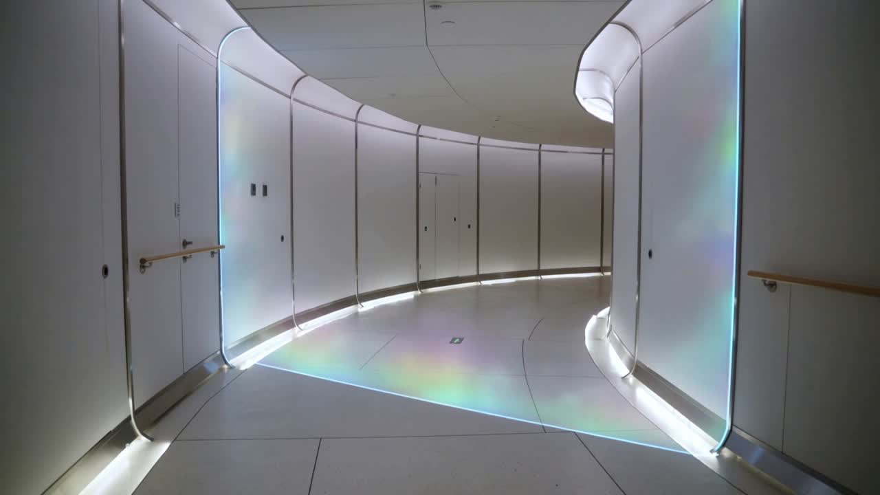 Curved corridor staying static while cove light shifting rainbow patch forward, showing design cues