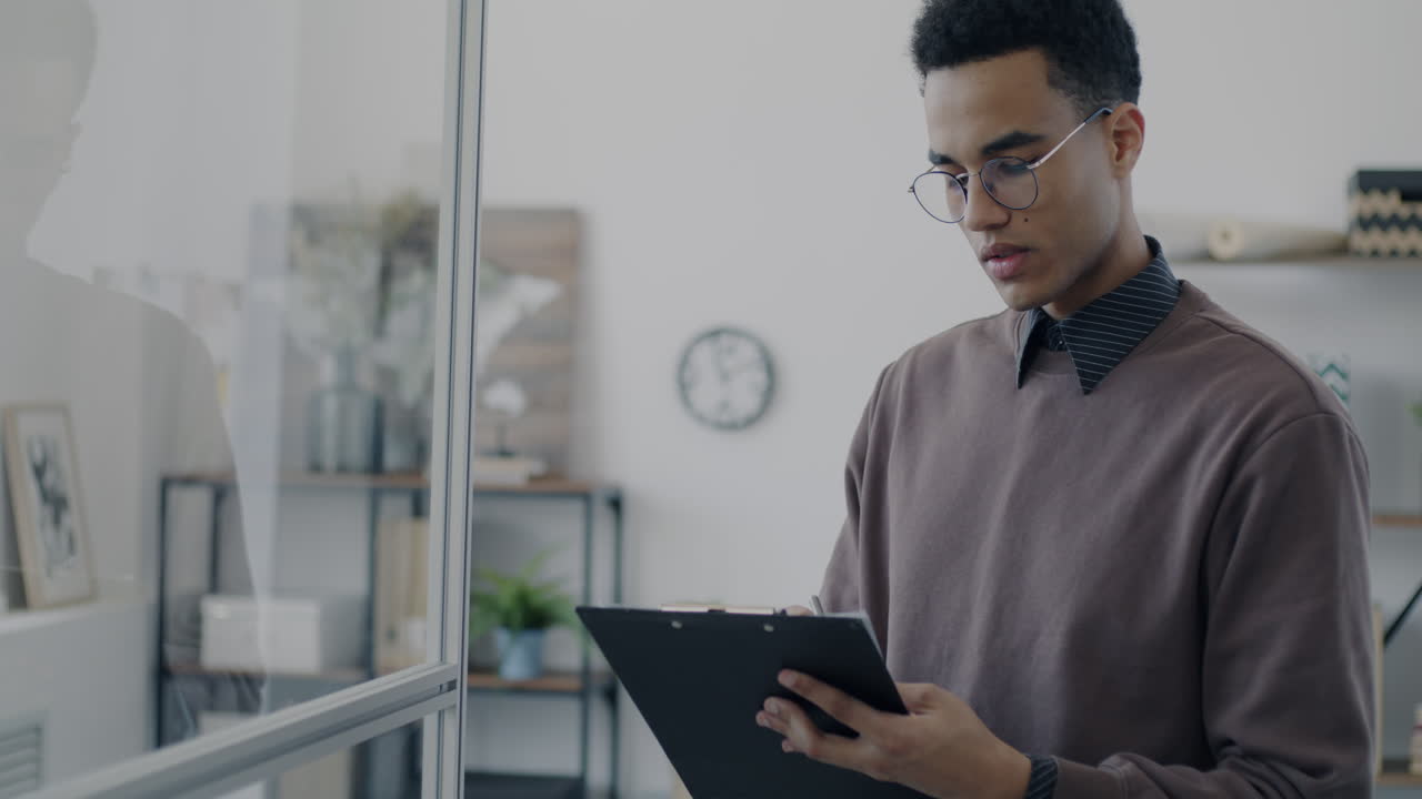 Young professional taking notes in a modern office