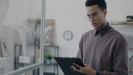 young professional taking notes in a modern office