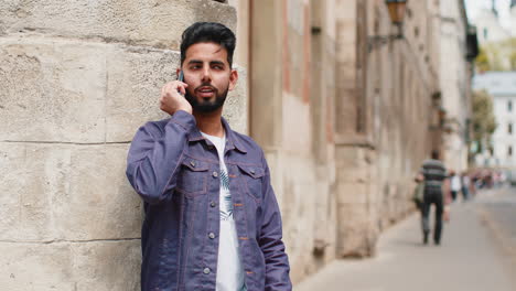 a man talking on his phone on a city street