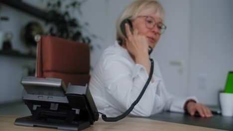 woman talking on phone in office