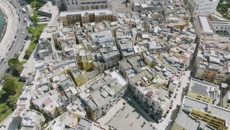 Slow-aerial-flyover-of-the-old-and-beautiful-buildings-and-skinny-streets-of-Old-Town-Bari,-Italy