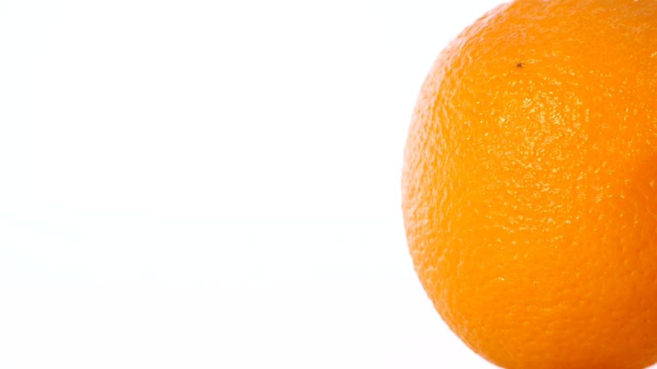 Nærbillede rotation af appelsin på en hvid baggrund.