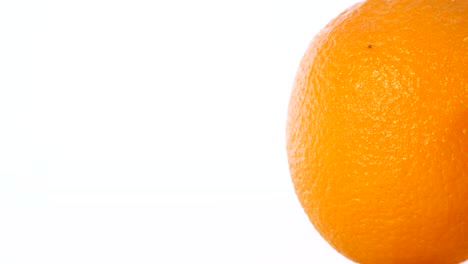 close-up rotation of orange on a white background