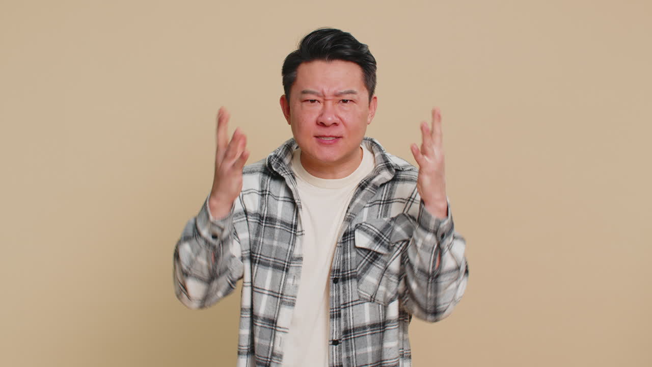 Upset frustrated annoyed asian man in indignant expression quarreling asking reason of conflict