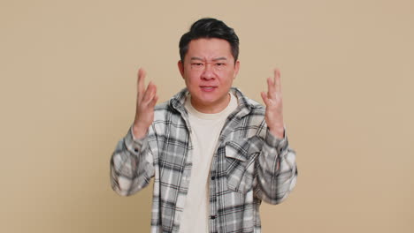 upset frustrated annoyed asian man in indignant expression quarreling asking reason of conflict