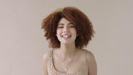 portrait-of-young-mixed-race-woman-with-afro-laughing-playful-afro