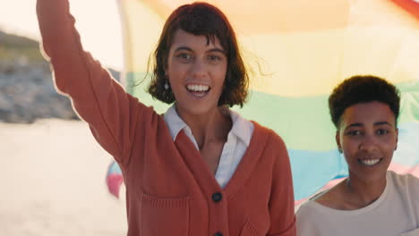 Lesbian-couple,-women-or-pride-flag-on-beach-date