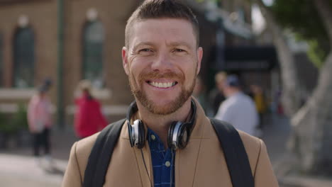 slow motion portrait of charming caucasian man smiling happy in urban background