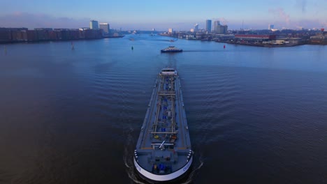 aerial tilt over tanker ship coming from the north sea canal in amsterdam, twilight