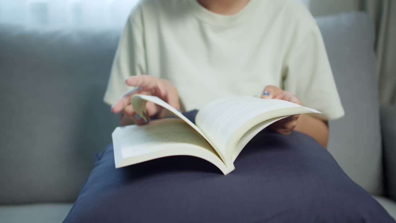 A person enjoys reading a book in a comfortable home environment
