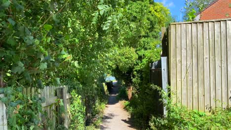 Windy-sunny-summer-day-in-Devizes-England,-green-trees-and-a-little-walking-path-to-a-canal,-4K-shot