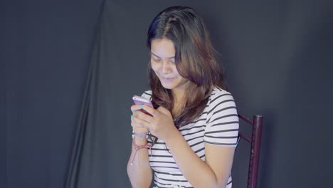 Medium-shot-of-happy-young-asian-girl,-write-message-on-phone