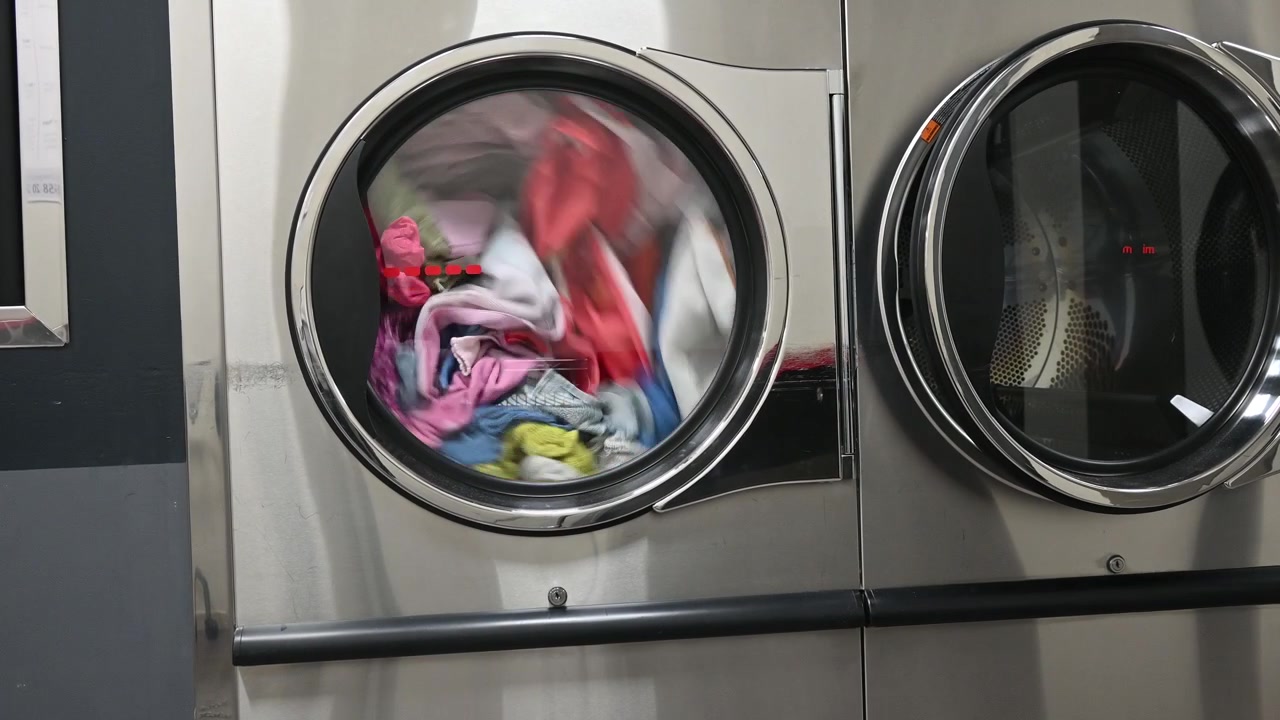 Industrial washing machine operating in laundromat