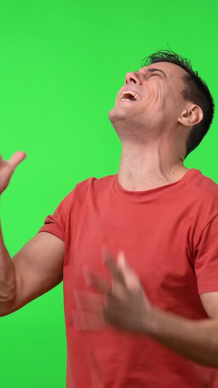 Man with hand gestures in front of green screen