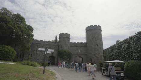 visitors entering a historic castle entrance