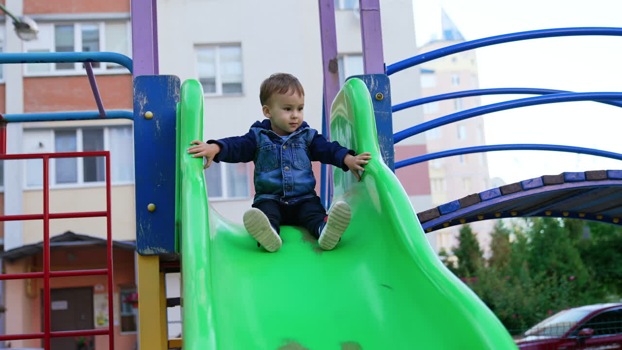 Toddler Boy on a Playground Slide