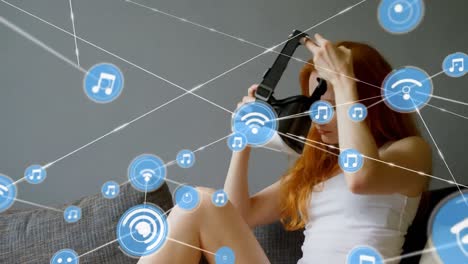 Animation-of-network-of-connections-with-icons-over-woman-wearing-vr-headset