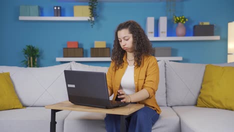 Negative-expression-of-young-woman-using-laptop.