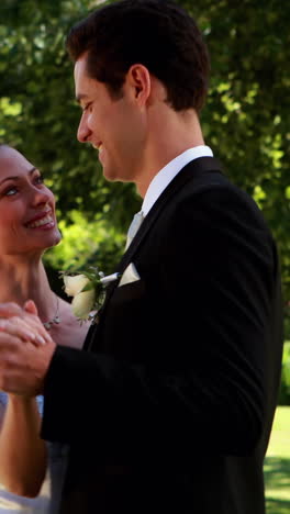 happy newlyweds dancing on their wedding day in the country