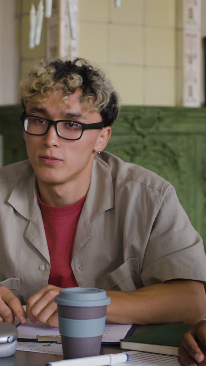 Young Man Actively Engaged in a Casual Indoor Meeting