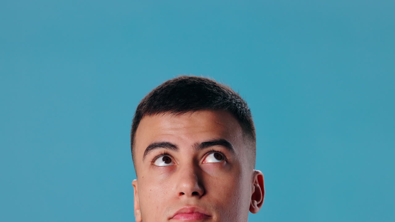 Man looking up on blue background