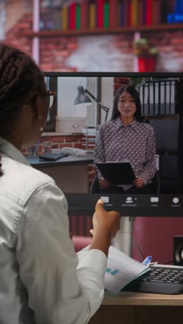 vertical video remote worker calls manager using internet videocall to ask for feedback