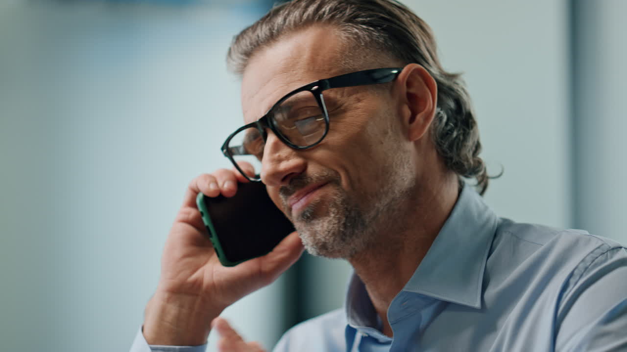 Angry director arguing smartphone call indoors portrait. Man speaking mobile