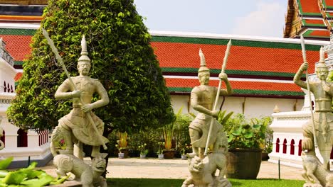 statues and architecture at a bangkok temple