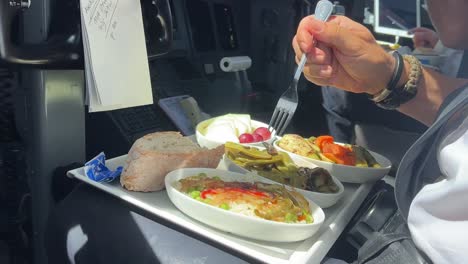 pilot eating his crew meal during a real flight