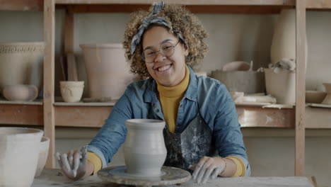 woman creating pottery on a pottery wheel