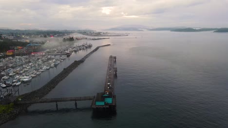 Boat-Harbor-Pier-on-Campbell-River,-Vancouver,-British-Columbia---Aerial-at-Sunset