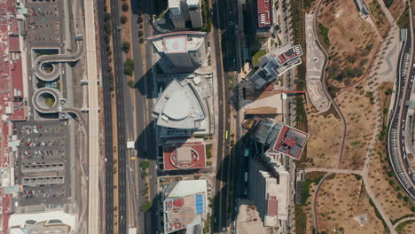 Aerial-birds-eye-overhead-top-down-panning-view-of-multilane-road-leading-along-with-group-of-tall-buildings-in-Santa-Fe.-Mexico-City,-Mexico.