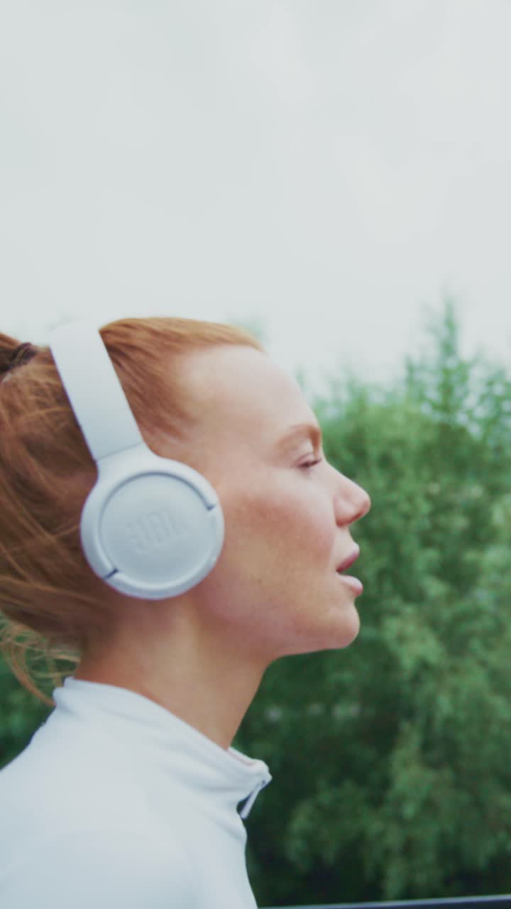 A Dedicated Runner Enjoying the Rhythm of Her Favorite Tunes While Jogging Outdoors, Embracing the Elements and the Thrill of an Active Lifestyle