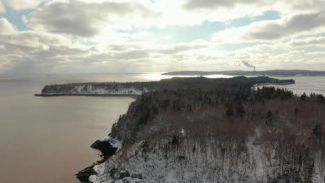 Aerial-view-of-the-snow-covered-Bay-of-Fundy-coastline-during-winter