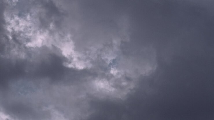 A captivating timelapse of post-storm clouds drifting over Indiana, featuring fluffy white and gray clouds against a serene blue sky, capturing the dynamic beauty of nature's aftermath.