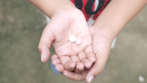 child holding pills