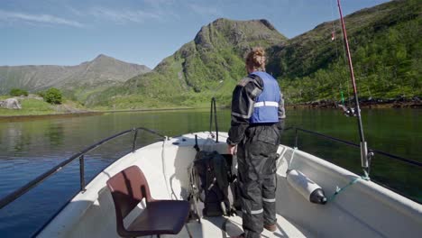 Norwegian-Traveler-Cruising-While-Holding-His-Camera-With-Picturesque-View-During-Summer-In-Norway