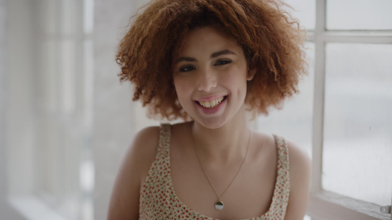 retrato de una joven de raza mixta feliz sonriendo alegre disfrutando de un estilo de vida relajado e independiente estudiante excitada en un nuevo apartamento