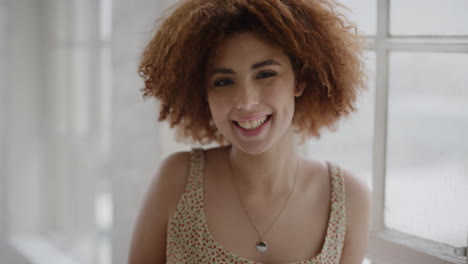 portrait of happy young mixed race girl smiling cheerful enjoying relaxed independent lifestyle female student excited in new apartment