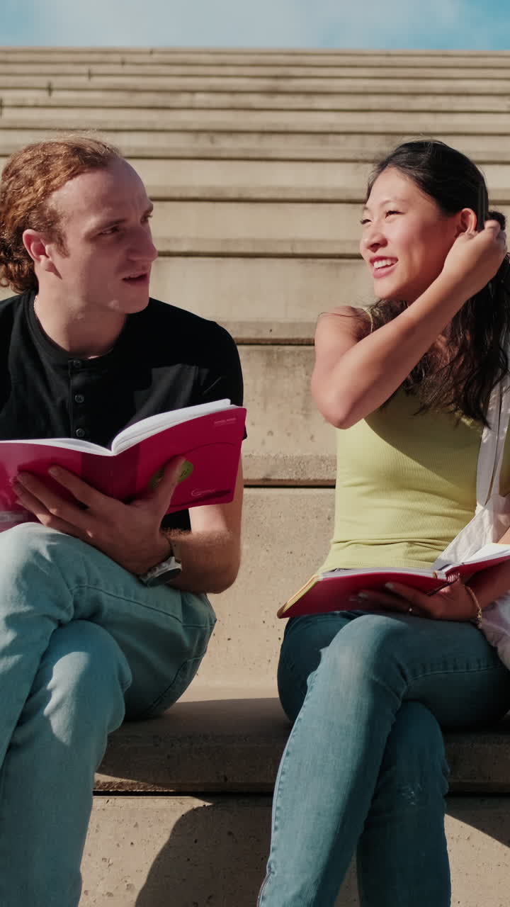 A Girl and a boy, male and female students having fun talking outdoors