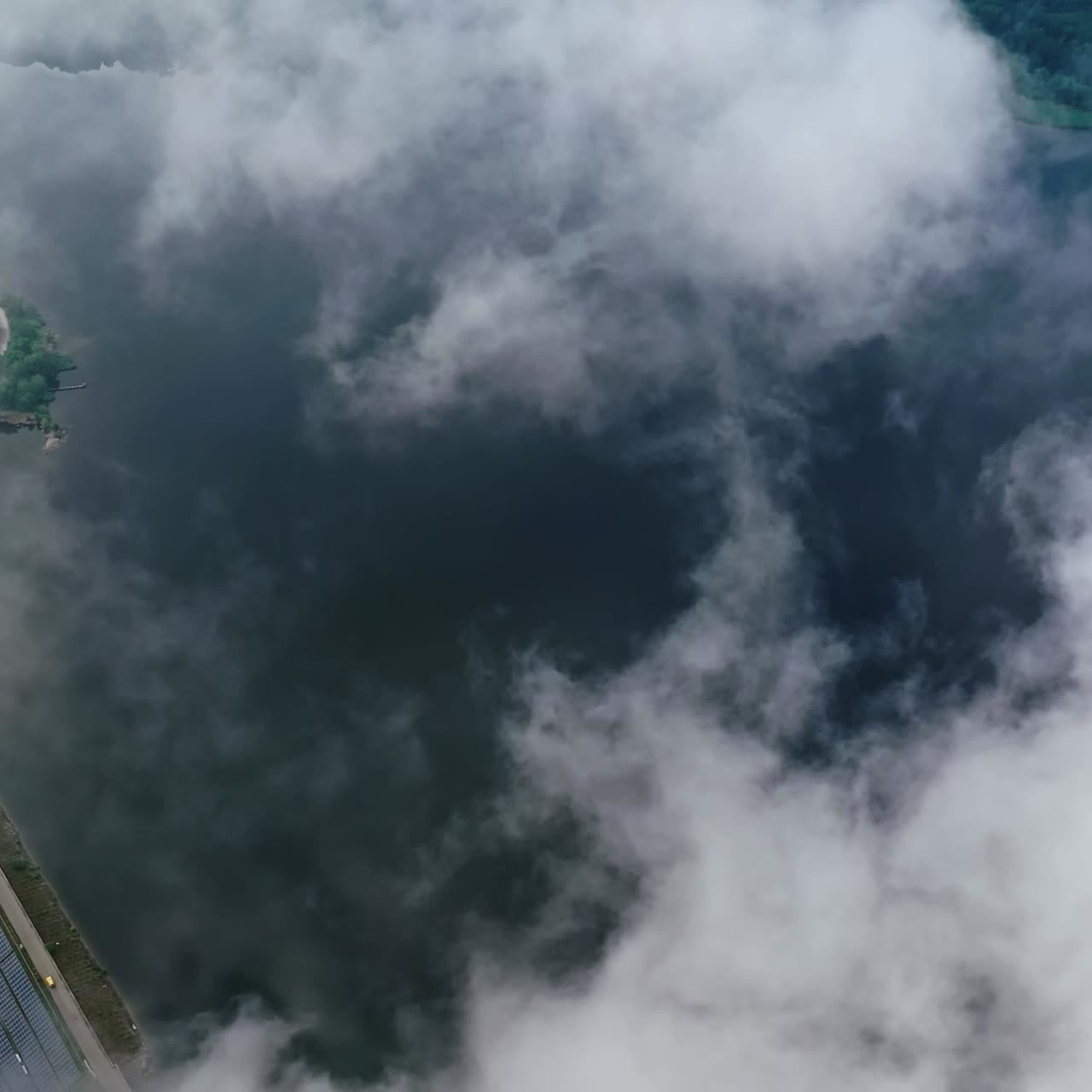 Amazing view from the sky. Flight among clouds on water background near the countryside. Aerial view.