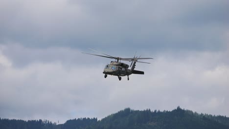 the black hawk military helicopter thanks the spectators, turns away and flies away. this at airpower 2024
