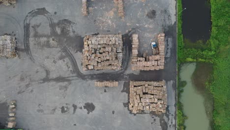 aerial view of recycling center with cardboard piles and forklift