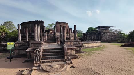 view of the historic polonnaruwa vatadage with the scaffolded thuparamaya temple in the background, showcasing ancient buddhist architecture in sri lanka.