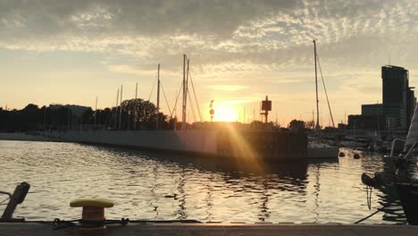 a beautiful sunset in a marina by the sea