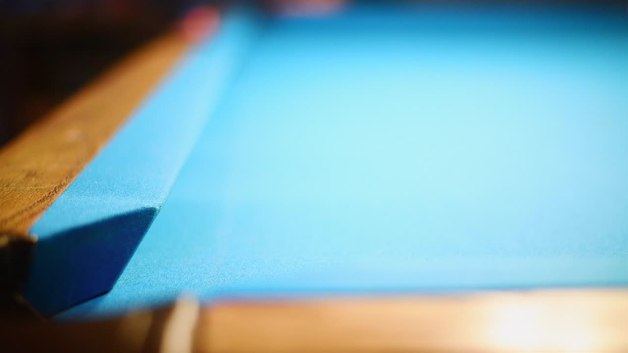 Long 8-ball shot on a blue cloth pool table