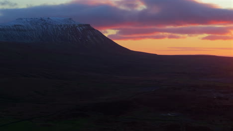 establishing aerial shot of snowy ingleborough yorkshire at sunset