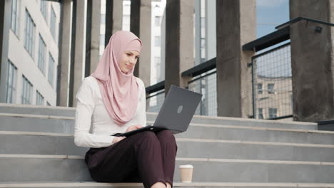 woman working on laptop outdoors